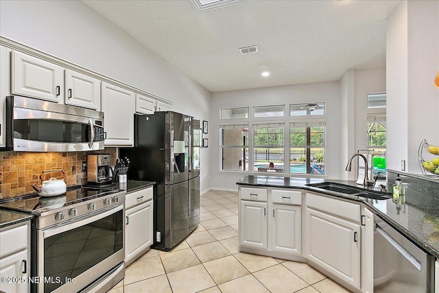 185 Edgewater Branch Dr, Saint Johns, FL 32259 - kitchen featuring a sink, stainless steel appliances, light tile patterned floors, backsplash, and visible vents