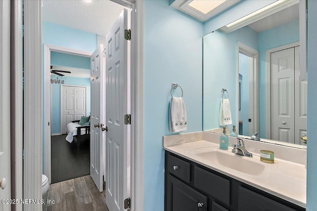 185 Edgewater Branch Dr, Saint Johns, FL 32259 - bathroom featuring ensuite bath, vanity, toilet, a textured ceiling, and wood finished floors