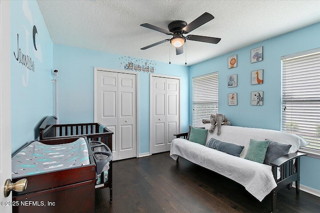 185 Edgewater Branch Dr, Saint Johns, FL 32259 - bedroom with ceiling fan, a textured ceiling, baseboards, two closets, and dark wood-style floors