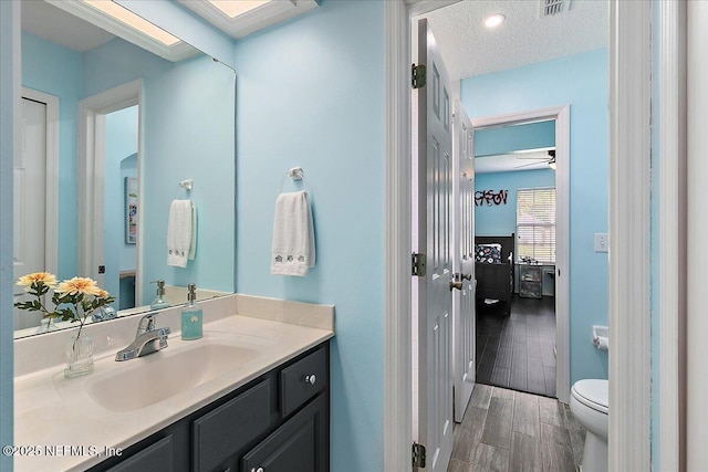 185 Edgewater Branch Dr, Saint Johns, FL 32259 - bathroom featuring ceiling fan, wood finished floors, vanity, toilet, and connected bathroom