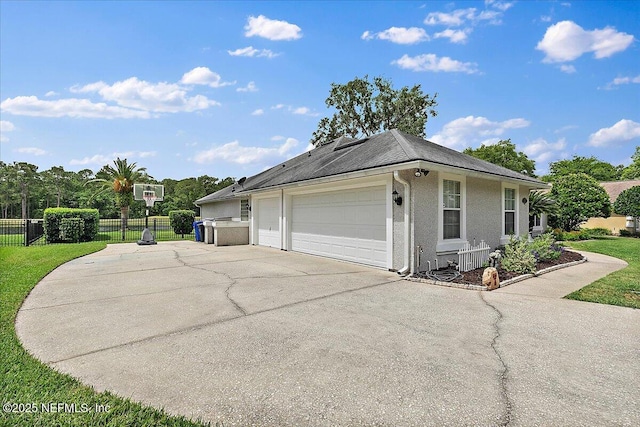 185 Edgewater Branch Dr, Saint Johns, FL 32259 - view of side of home featuring fence, a garage, stucco siding, a lawn, and driveway