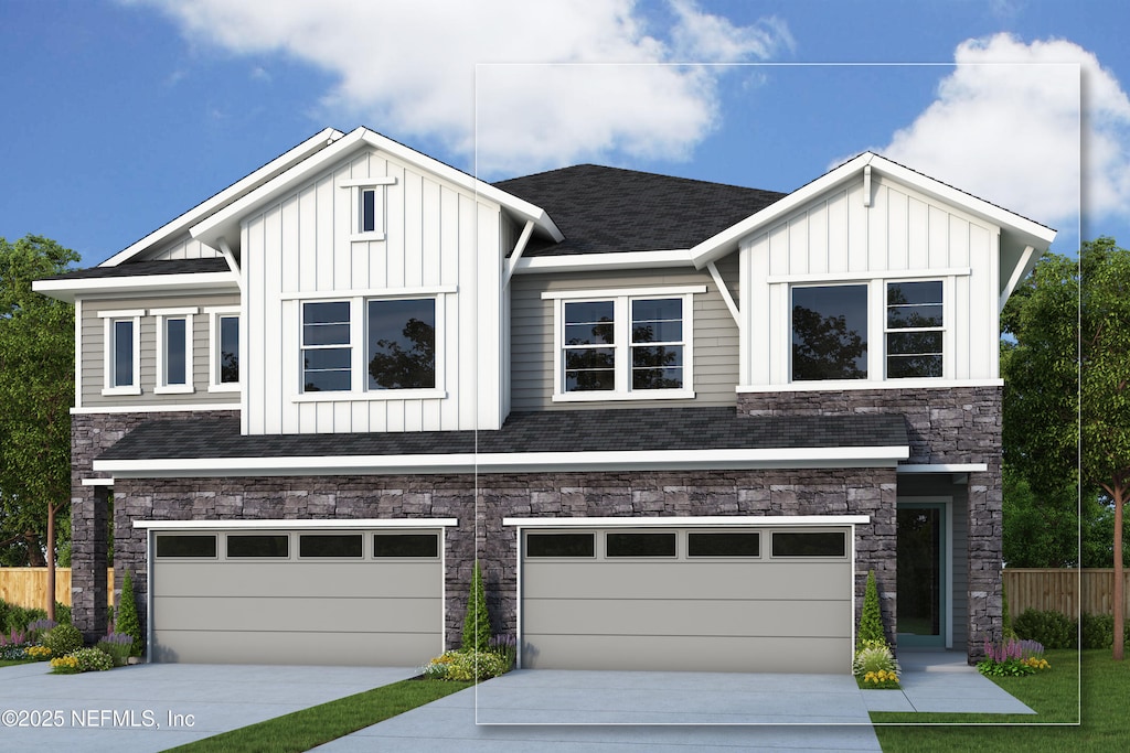 view of front of house with a garage, board and batten siding, and stone siding