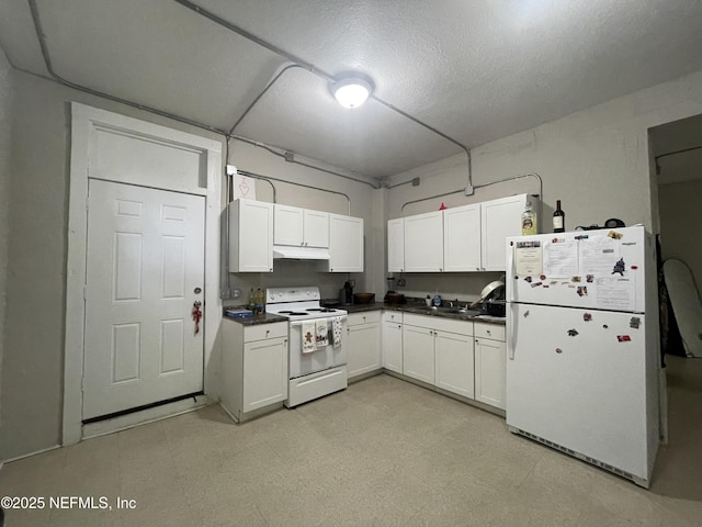 kitchen featuring dark countertops, white cabinets, light floors, under cabinet range hood, and white appliances