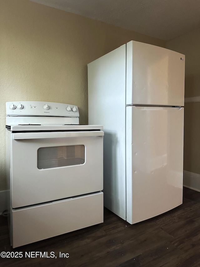 kitchen with dark wood-style flooring and white appliances