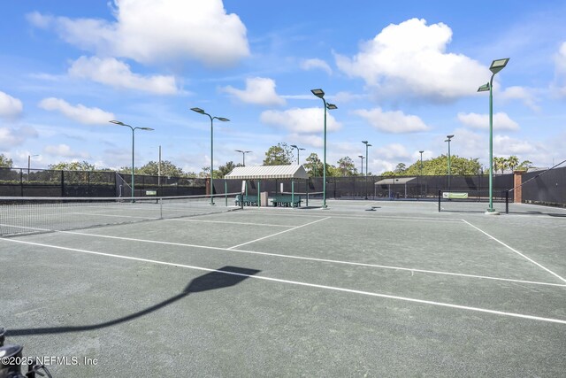 view of sport court featuring fence