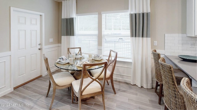 119 Craig Ct, Saint Johns, FL 32092 - dining space featuring wood tiled floor, wainscoting, and a decorative wall