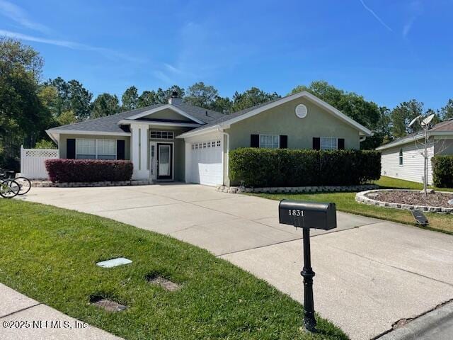 1831 Moss Creek Dr SW, Fleming Island, FL 32003 - ranch-style home featuring an attached garage, driveway, and a front yard