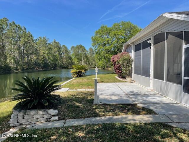 1831 Moss Creek Dr SW, Fleming Island, FL 32003 - view of yard with a water view, a patio, and a sunroom
