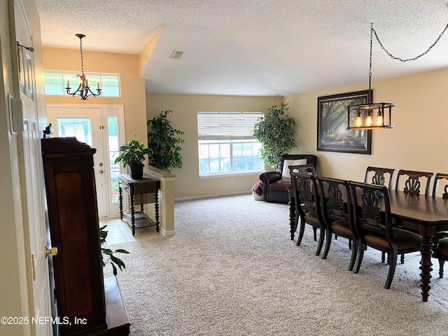 1831 Moss Creek Dr SW, Fleming Island, FL 32003 - carpeted dining space featuring a textured ceiling, a notable chandelier, and plenty of natural light