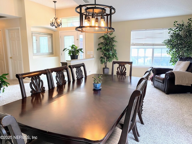 1831 Moss Creek Dr SW, Fleming Island, FL 32003 - carpeted dining room featuring a textured ceiling, an inviting chandelier, and a healthy amount of sunlight