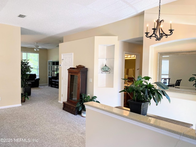 1831 Moss Creek Dr SW, Fleming Island, FL 32003 - hallway featuring visible vents, carpet flooring, and a chandelier