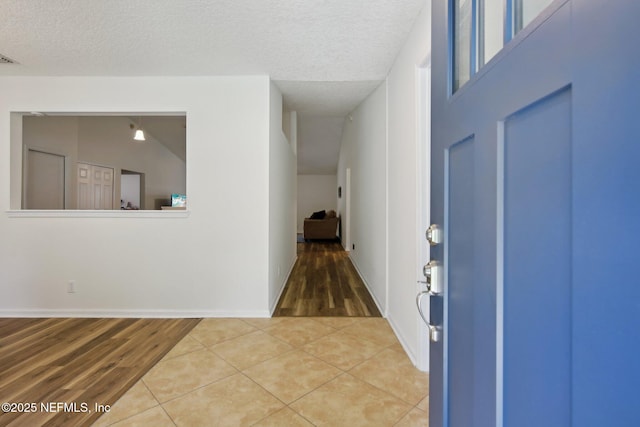 13198 Ebbtide Ct, Jacksonville, FL 32225 - entrance foyer featuring light wood finished floors, baseboards, and a textured ceiling