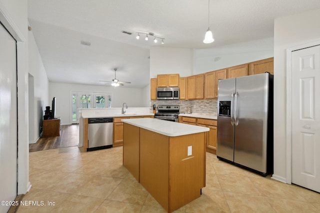 13198 Ebbtide Ct, Jacksonville, FL 32225 - kitchen with appliances with stainless steel finishes, a ceiling fan, light countertops, a peninsula, and light tile patterned flooring