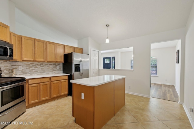 13198 Ebbtide Ct, Jacksonville, FL 32225 - kitchen with appliances with stainless steel finishes, backsplash, a center island, light countertops, and light tile patterned flooring