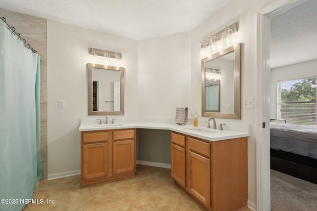 13198 Ebbtide Ct, Jacksonville, FL 32225 - full bathroom featuring a textured ceiling, double vanity, baseboards, ensuite bathroom, and tile patterned flooring