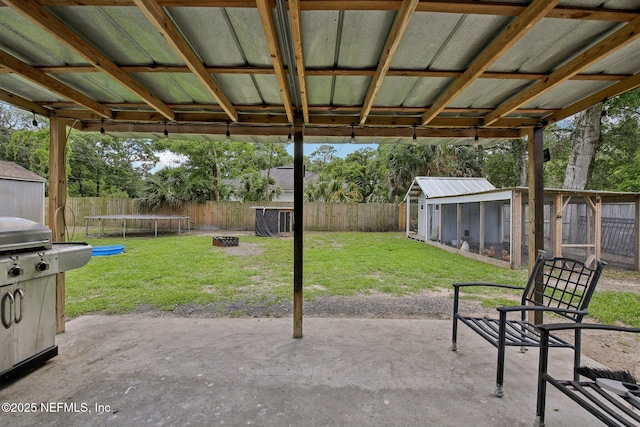 13198 Ebbtide Ct, Jacksonville, FL 32225 - view of patio / terrace featuring a trampoline, an outbuilding, and a storage unit