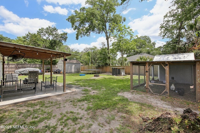 13198 Ebbtide Ct, Jacksonville, FL 32225 - view of yard with an outbuilding, exterior structure, a patio area, and a shed