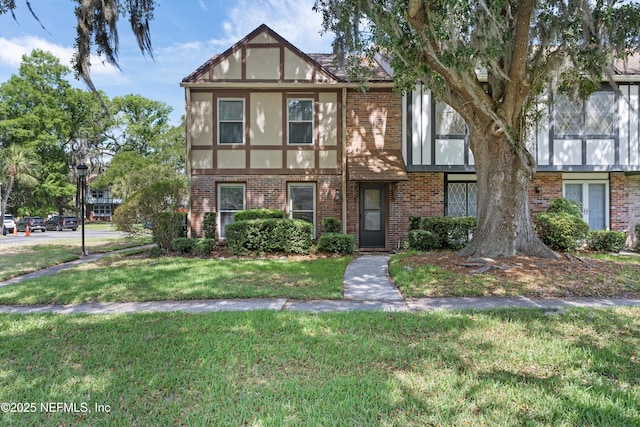 8195 Trafalgar Sq, Jacksonville, FL 32217 - view of front of property with stucco siding, brick siding, and a front lawn