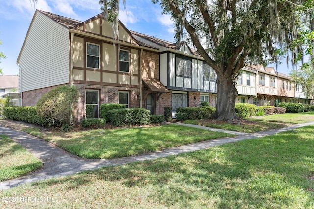 8195 Trafalgar Sq, Jacksonville, FL 32217 - view of front of home featuring brick siding and a front yard