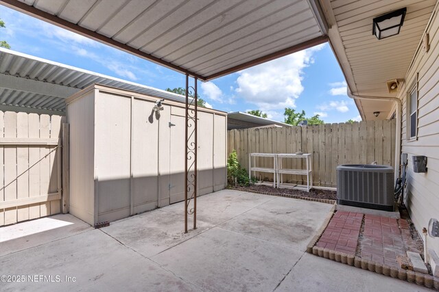 8195 Trafalgar Sq, Jacksonville, FL 32217 - view of patio featuring cooling unit, an outbuilding, a storage shed, and fence
