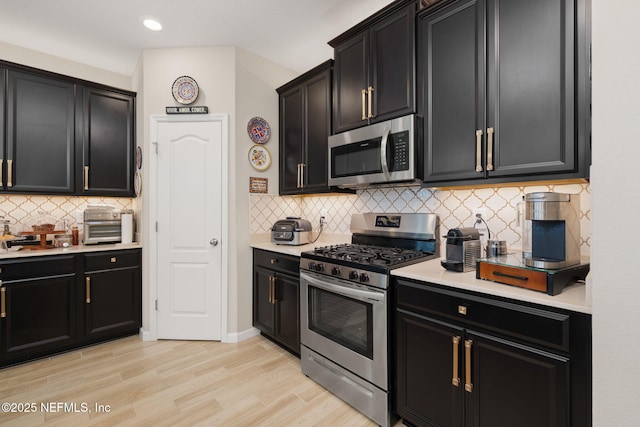 124 Tintamarre Dr, Saint Augustine, FL 32259 - kitchen featuring dark cabinetry, light countertops, and appliances with stainless steel finishes
