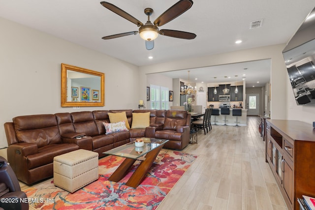 124 Tintamarre Dr, Saint Augustine, FL 32259 - living area featuring plenty of natural light, ceiling fan with notable chandelier, visible vents, and light wood-type flooring