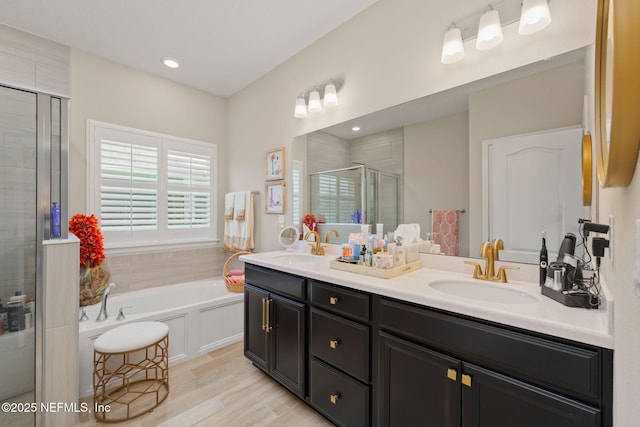 124 Tintamarre Dr, Saint Augustine, FL 32259 - bathroom featuring double vanity, a bath, a stall shower, wood finished floors, and a sink