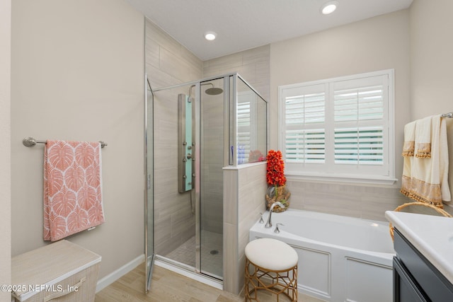 124 Tintamarre Dr, Saint Augustine, FL 32259 - full bathroom with a stall shower, recessed lighting, a garden tub, and wood finished floors