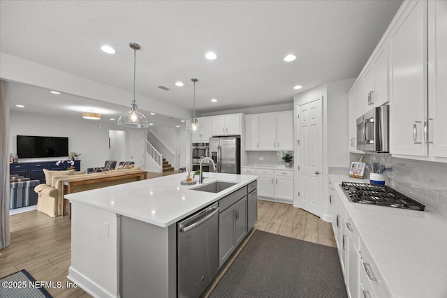 77 Palisade Dr, Saint Augustine, FL 32092 - kitchen featuring white cabinets, appliances with stainless steel finishes, a sink, recessed lighting, and light wood-type flooring
