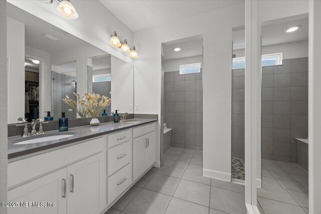 77 Palisade Dr, Saint Augustine, FL 32092 - bathroom featuring double vanity, a walk in shower, a sink, and tile patterned flooring