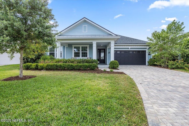 77 Palisade Dr, Saint Augustine, FL 32092 - ranch-style house featuring decorative driveway, a garage, a front lawn, and covered porch