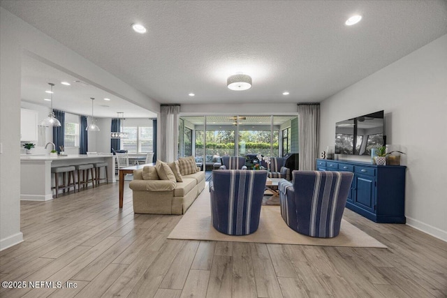 77 Palisade Dr, Saint Augustine, FL 32092 - living room with baseboards, light wood finished floors, and a wealth of natural light