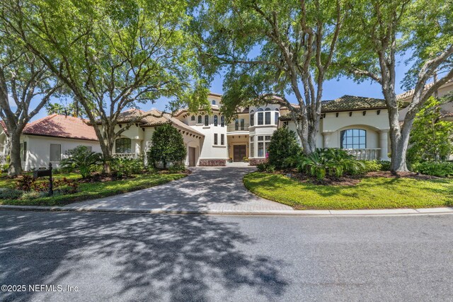 108 Harbourmaster Ct, Ponte Vedra Beach, FL 32082 - mediterranean / spanish-style home featuring driveway, stucco siding, an attached garage, and a tiled roof