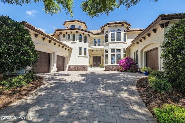 108 Harbourmaster Ct, Ponte Vedra Beach, FL 32082 - mediterranean / spanish-style house featuring a balcony, a garage, stucco siding, decorative driveway, and a tiled roof
