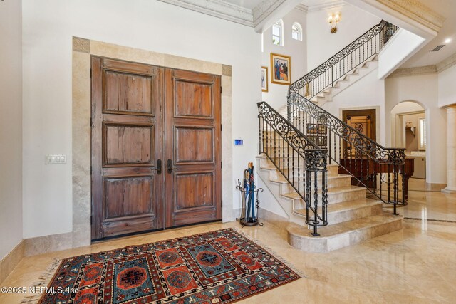 108 Harbourmaster Ct, Ponte Vedra Beach, FL 32082 - foyer with arched walkways, ornamental molding, stairs, and a high ceiling