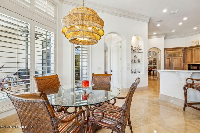 108 Harbourmaster Ct, Ponte Vedra Beach, FL 32082 - dining area with arched walkways, ornamental molding, recessed lighting, and a chandelier
