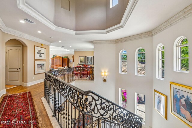 108 Harbourmaster Ct, Ponte Vedra Beach, FL 32082 - hall featuring ornamental molding, an upstairs landing, a towering ceiling, wood finished floors, and baseboards