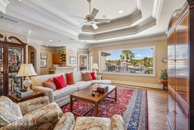 108 Harbourmaster Ct, Ponte Vedra Beach, FL 32082 - living room with ornamental molding, a tray ceiling, a ceiling fan, wood finished floors, and baseboards