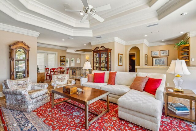 108 Harbourmaster Ct, Ponte Vedra Beach, FL 32082 - living room with ceiling fan, arched walkways, a tray ceiling, crown molding, and recessed lighting