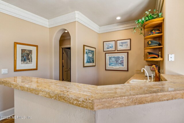 108 Harbourmaster Ct, Ponte Vedra Beach, FL 32082 - bar area featuring a sink, crown molding, arched walkways, and recessed lighting