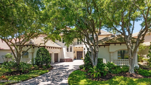 108 Harbourmaster Ct, Ponte Vedra Beach, FL 32082 - mediterranean / spanish-style house featuring stucco siding, driveway, a tiled roof, and a garage