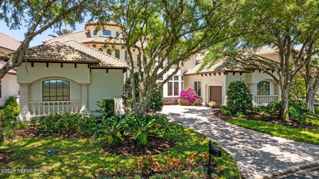 108 Harbourmaster Ct, Ponte Vedra Beach, FL 32082 - mediterranean / spanish-style home featuring stucco siding, a tiled roof, driveway, and an attached garage