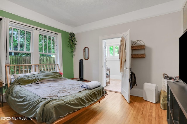 bedroom with baseboards and light wood-style flooring
