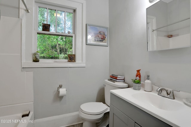 full bath with vanity, a shower, and toilet
