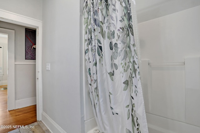 bathroom featuring baseboards and wood finished floors