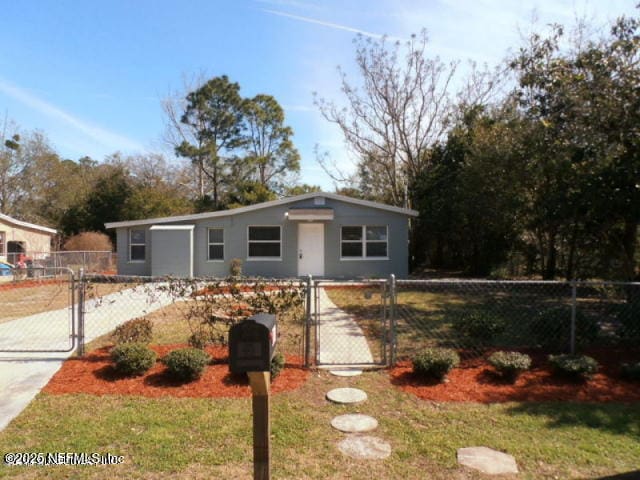 view of front of home with fence, a gate, and stucco siding