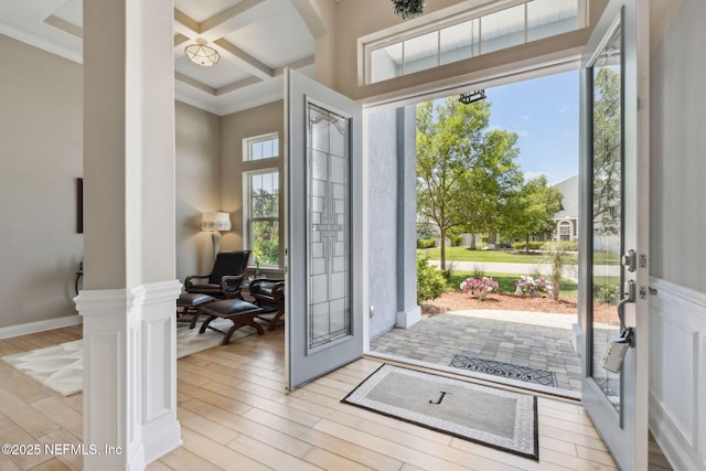 entrance foyer with ornamental molding, coffered ceiling, wood finished floors, and beamed ceiling