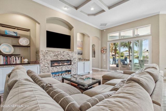living room with visible vents, baseboards, a high ceiling, arched walkways, and coffered ceiling