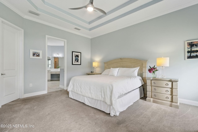bedroom with a tray ceiling, ornamental molding, carpet flooring, and visible vents