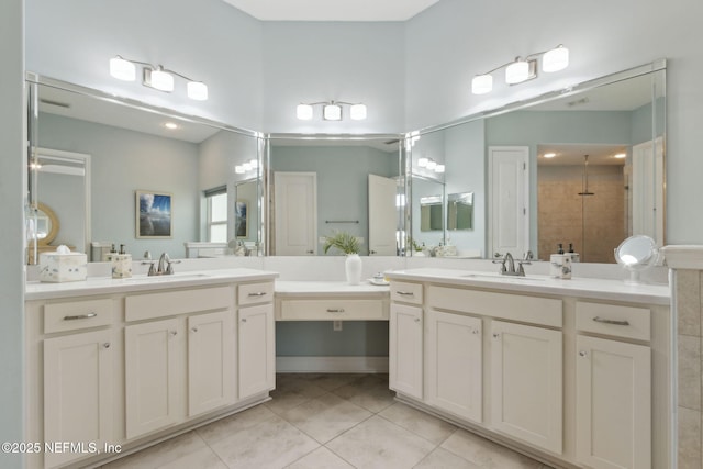 bathroom featuring a sink, tile patterned flooring, a tile shower, and two vanities